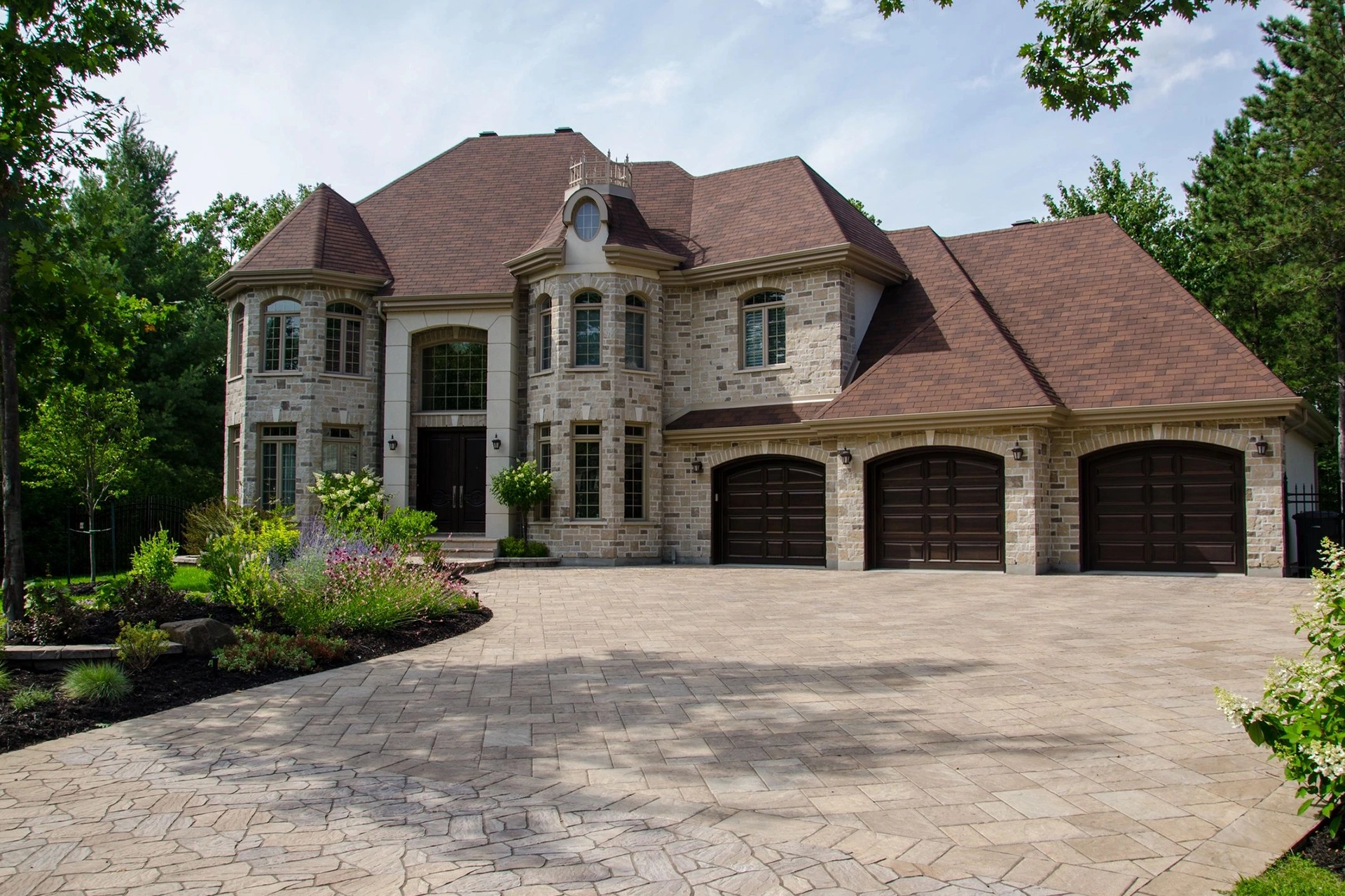 A large brick house with two garages.